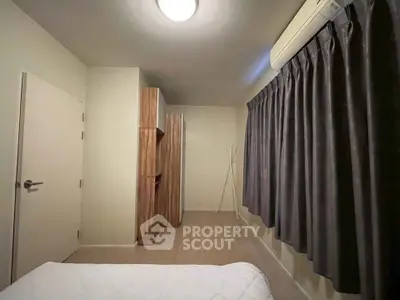 Spacious bedroom with modern air conditioning and elegant curtains