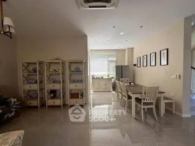 Spacious living room with elegant dining area and stylish decor in modern home.