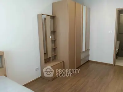 Modern bedroom with sleek wooden wardrobe and elegant flooring