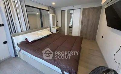 Modern bedroom with stylish decor and large mirror wardrobe