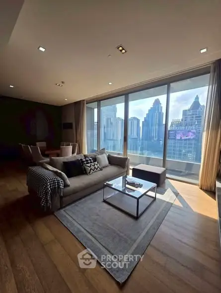 Luxurious living room with stunning city view and modern decor in high-rise apartment.