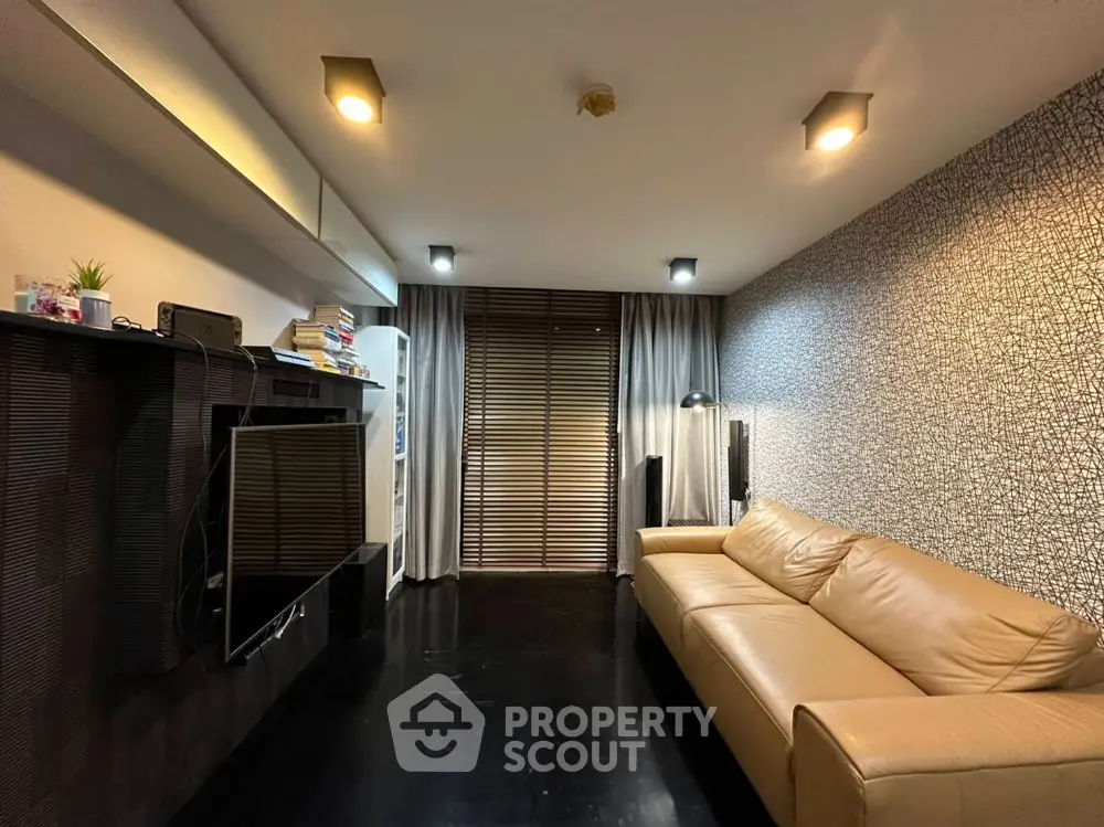 Modern living room with sleek design, leather sofa, and wall-mounted TV, perfect for stylish urban living.