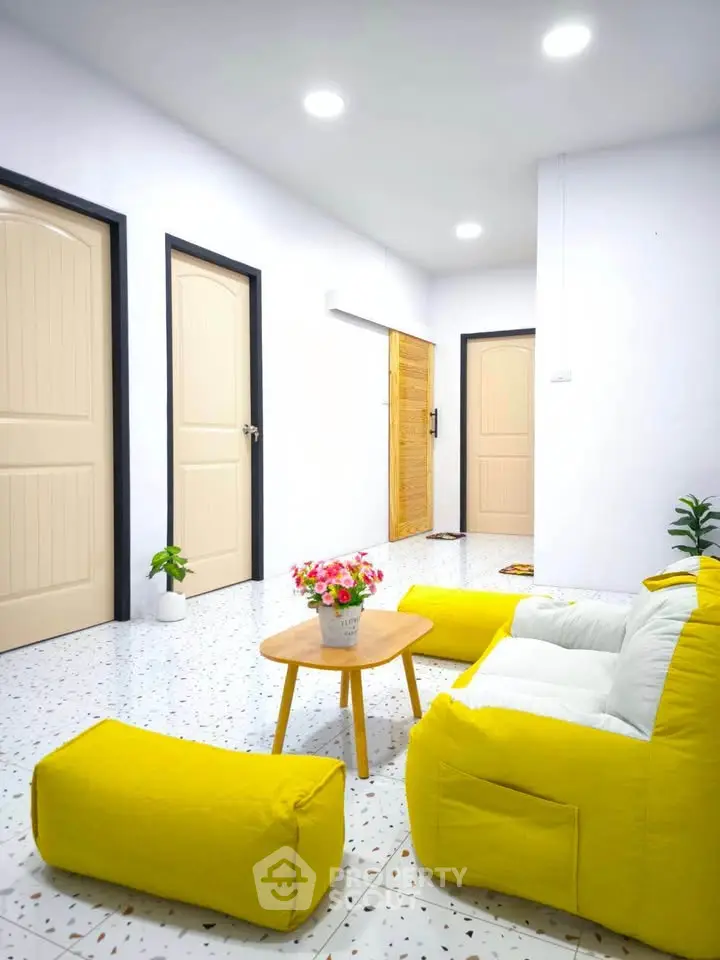 Bright living room with yellow sofa and modern decor