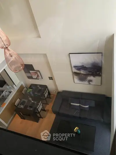 Modern loft-style living room with high ceiling and elegant decor