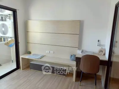 Modern study room with sleek desk and chair, featuring a minimalist design and natural light.