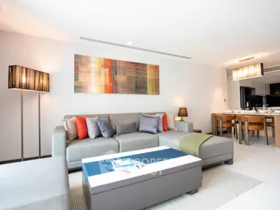 Spacious modern living room with stylish decor and dining area in open layout.