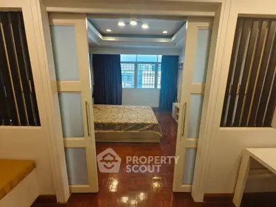 Spacious bedroom with elegant sliding doors and natural light