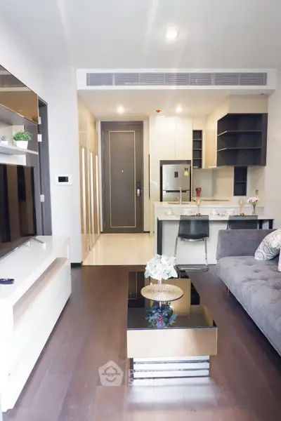 Modern living room with open kitchen layout and stylish decor