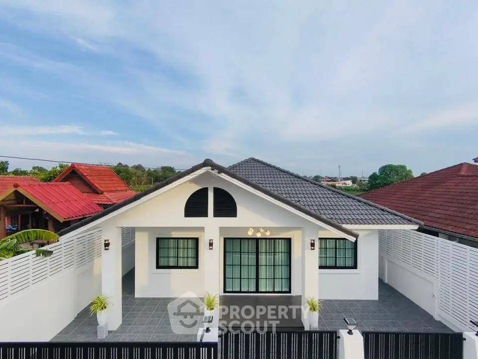 Charming single-story home with modern design and spacious driveway in a serene neighborhood.