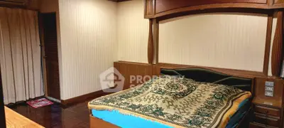 Cozy bedroom with wooden accents and patterned bedding