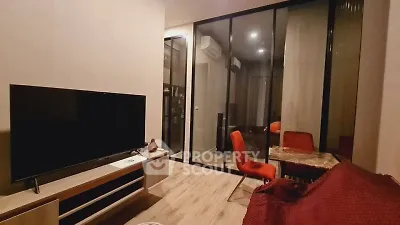 Modern living room with glass partition and stylish furniture