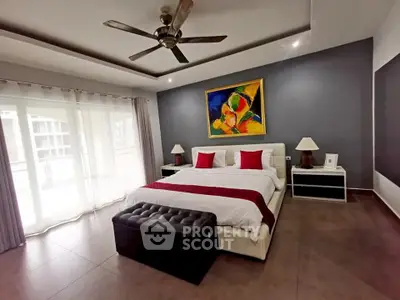 Luxurious bedroom with elegant decor and large windows for natural light.