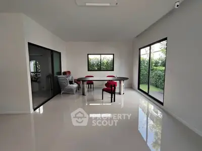 Spacious modern living room with garden view and sleek furniture