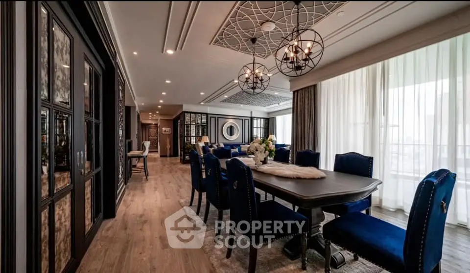 Luxurious dining room with elegant decor and modern lighting in a spacious open layout.