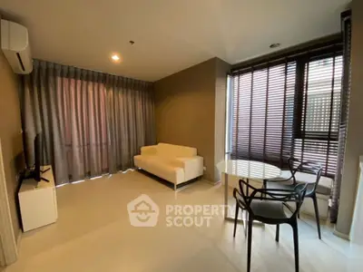 Modern living room with stylish furniture and large windows for natural light.