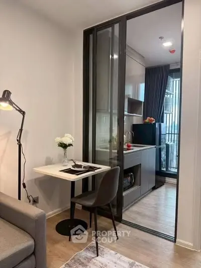 Modern compact apartment with sleek kitchen and cozy dining area