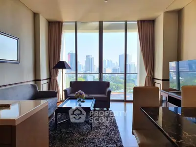 Spacious living room with city view, modern furniture, and large windows in a high-rise apartment.