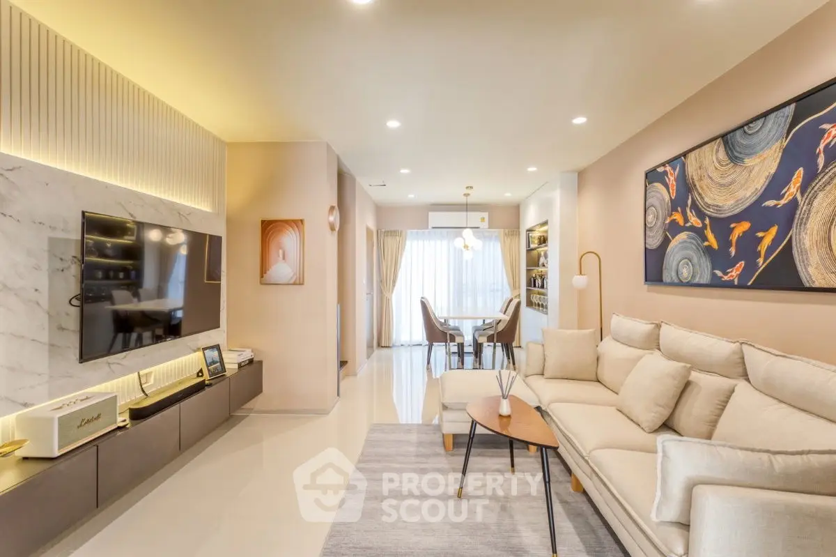 Modern living room with elegant decor and spacious layout, featuring a stylish sofa and wall art.