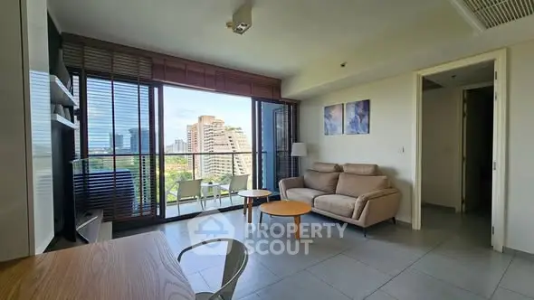 Modern living room with city view and stylish furniture in high-rise apartment.