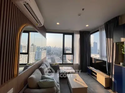 Modern living room with panoramic city view, stylish furniture, and natural light.