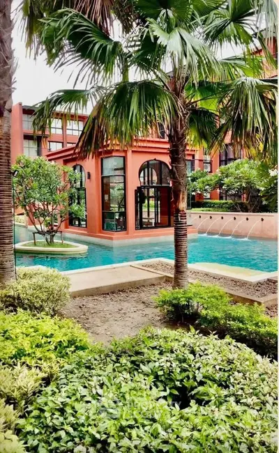 Luxurious residential complex with lush gardens and inviting swimming pool, perfect for relaxation and leisure.