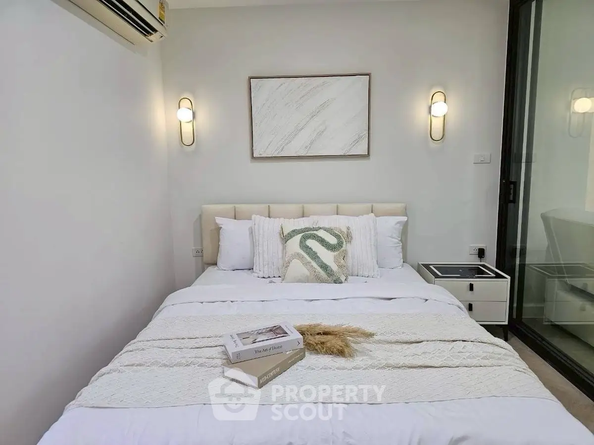 Cozy bedroom with modern decor and soft lighting, perfect for relaxation.