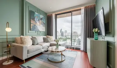 Stylish living room with city view, modern decor, and large windows.