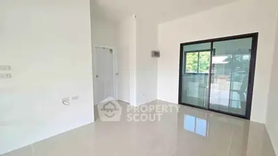 Bright and spacious room with sliding glass doors leading to a balcony, perfect for modern living.