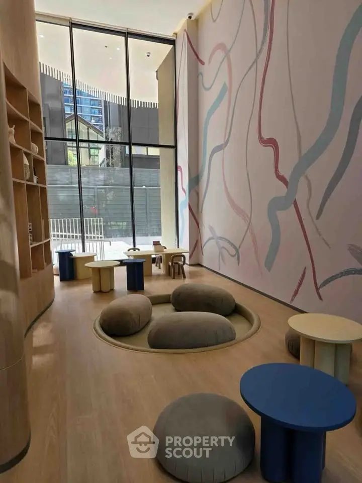 Modern building lobby with artistic wall design and cozy seating area