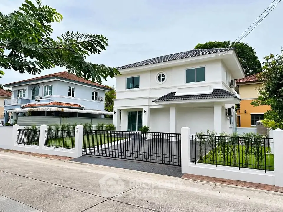 Stunning two-story modern house with spacious front yard and elegant exterior design.