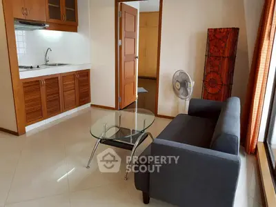 Cozy living room with modern kitchenette and stylish furniture