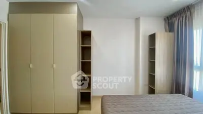 Modern bedroom with built-in wardrobe and natural light