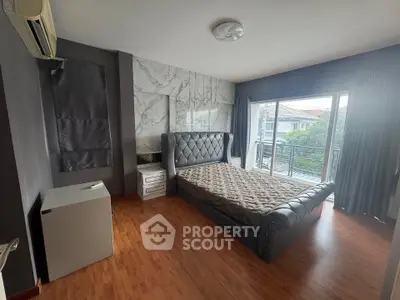 Spacious bedroom with elegant decor and balcony access in modern home