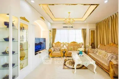 Luxurious living room with elegant gold accents and plush seating in a bright, spacious setting.