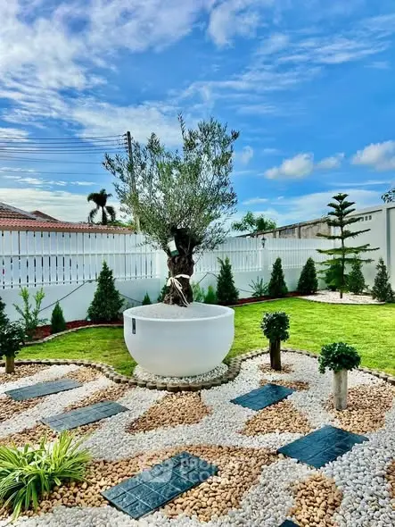 Stunning landscaped garden with unique stone design and lush greenery.