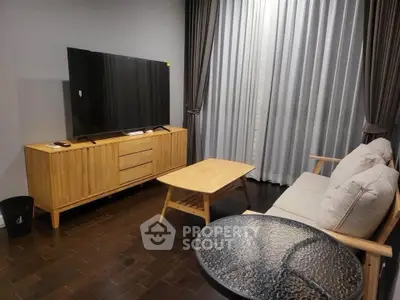 Modern living room with sleek wooden furniture and large flat-screen TV