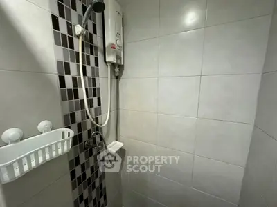 Compact bathroom with modern shower and tiled walls