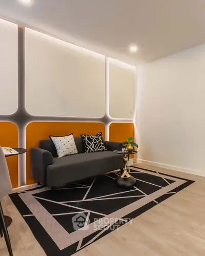 Modern living room with stylish decor and geometric rug, featuring a cozy sofa and ambient lighting.