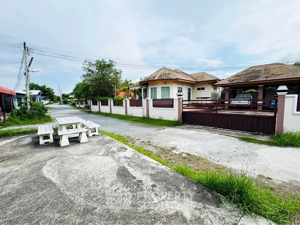 Charming suburban house with spacious driveway and lush greenery, perfect for family living.