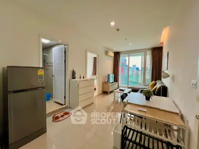 Modern living room with dining area and city view, featuring sleek furniture and natural light.