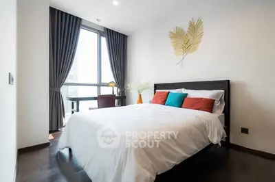Modern bedroom with large window and stylish decor