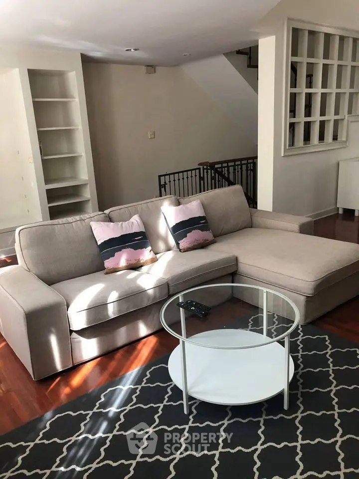 Spacious living room with modern sofa and stylish decor in a cozy home setting.
