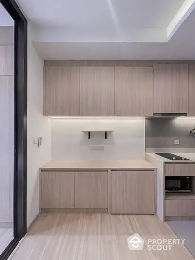 Modern kitchen with sleek cabinetry and built-in appliances in a contemporary apartment.