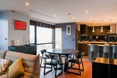 Modern open-plan living room with stylish kitchen and city view