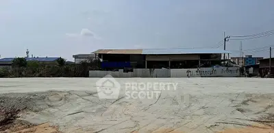 Spacious land plot with potential for development, featuring a partially constructed building and open surroundings.