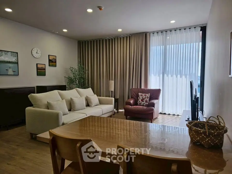 Spacious living room with modern decor and large windows for natural light.