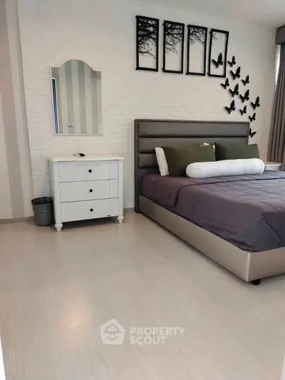 Modern bedroom with stylish decor and comfortable bed in a chic apartment.