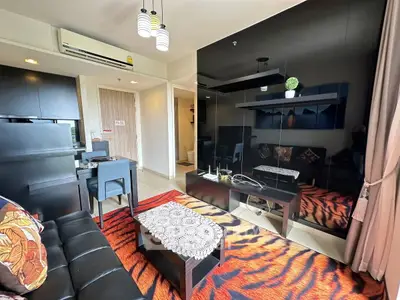Stylish modern living room with black furniture and vibrant decor