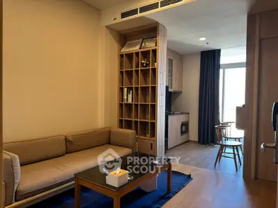 Modern living room with cozy sofa and stylish wooden furniture in open layout apartment.