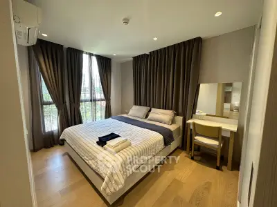 Spacious bedroom with large windows and elegant decor in modern apartment